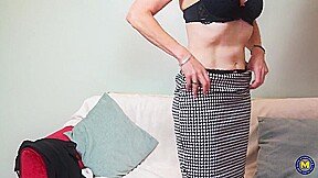 A very aroused older woman performs a sensual dance, removing her clothing, and then stimulates herself.